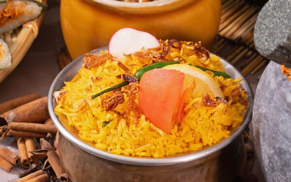 Lamb Biryani Rice topped with spices served in an Indian bowl
