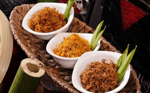 Serunding ayam, serunding daging and serunding kambing in a bowl decorated with pandan served during ramadan buffet dinner