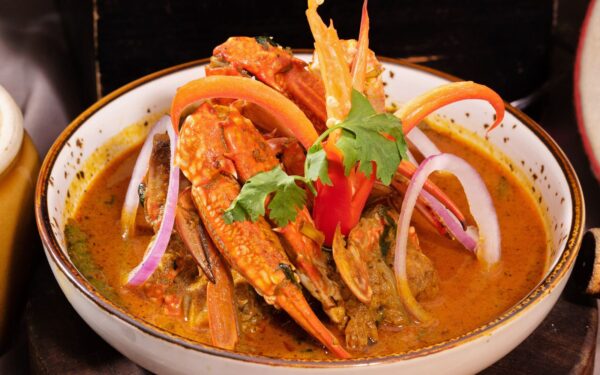 Kerala Crab Curry in a white bowl served during ramadan Dinner Buffet