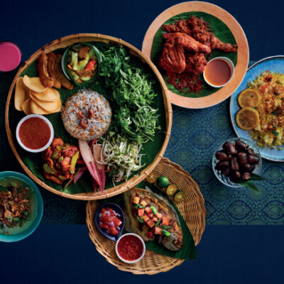 A table of nasi briyani, sambal udang petai, rendang, daging kerutuk, daging tetel and pucuk paku masak lemak. Buffet. Ramadan buffet