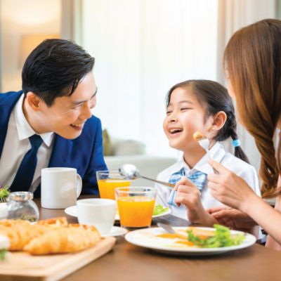 Father's Day Buffer dinner, image features a happy family consist father, mother and daughter smiling and laughing while eating