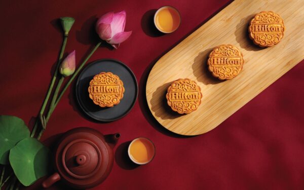 Hilton DoubleTree Baked mooncakes on a wooden tray and brown ceramic teapot