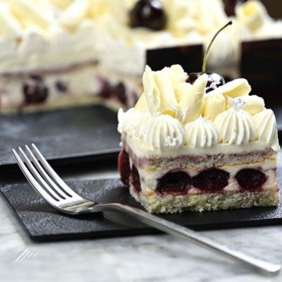black or white forest cake with dark pitted cherry and fresh cream