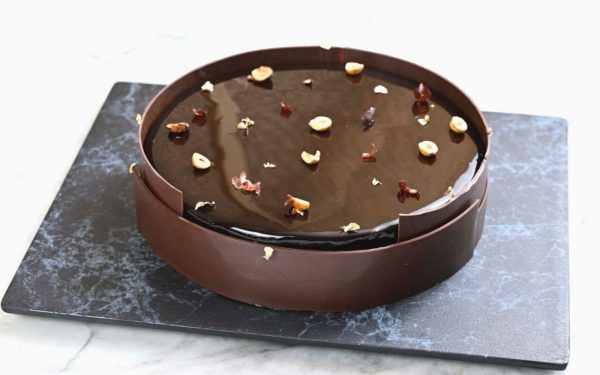 dark chocolate brownie decorated with hazelnut