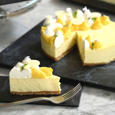 Classic cheesecake topped with fresh cream and silver flakes