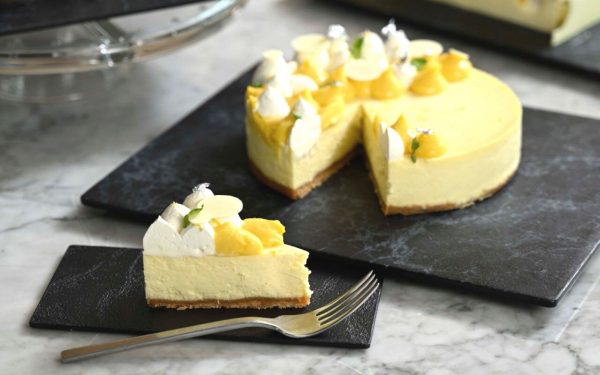 Classic cheesecake topped with fresh cream and silver flakes