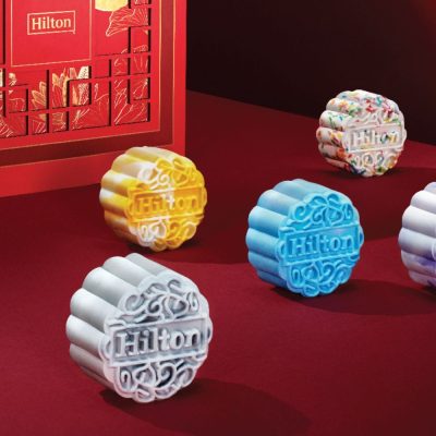 2023 Hilton Mooncake Box, image features a red mooncake box with oriental design. Box may include Premium Snow Skin Mooncakes Mooncake, Baked Mooncakes Mooncake, Durian Musang King Mooncake Mooncakes