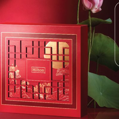 2023 Hilton Mooncake Box, image features a red mooncake box with oriental design. Box may include Premium Snow Skin Mooncakes Mooncake, Baked Mooncakes Mooncake, Durian Musang King Mooncake Mooncakes
