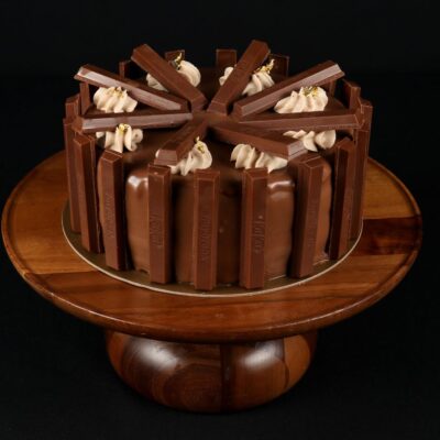 Kit Kat Tall Cake - Topped with a glossy milk chocolate glaze and garnished with Kit Kat bars.