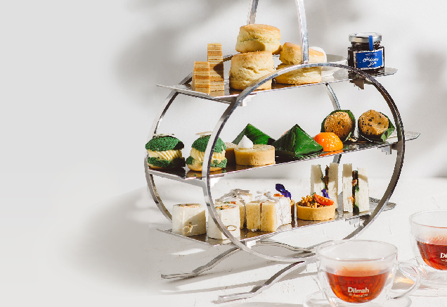 The photo shows a high tea set with three tiers.