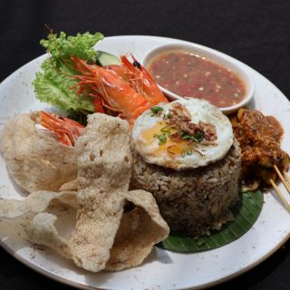 A plate of nasi goreng kampung with prawns and satay.