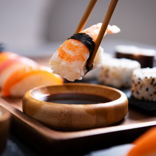 A piece of nigiri prawn sushi.