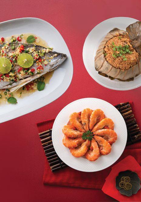 Three different Chinese dishes such as steamed prawns, yam rice and steamed fish.