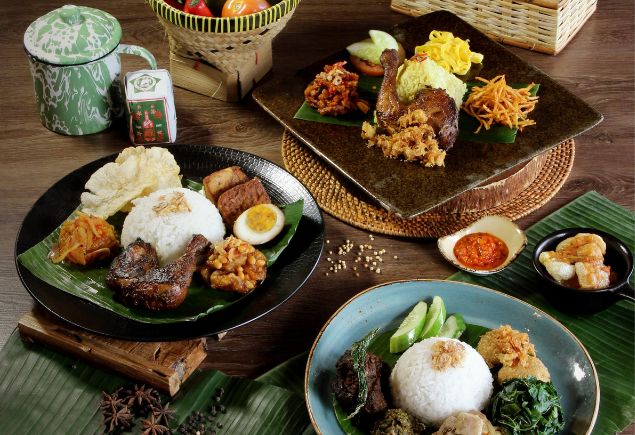 Three plates of traditional Indonesian cuisine are on the table.