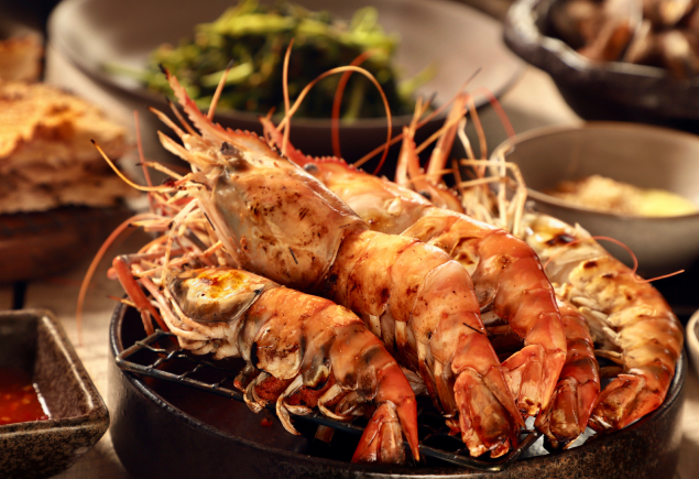 A plate of five giant freshwater prawns cooked in Chinese style.