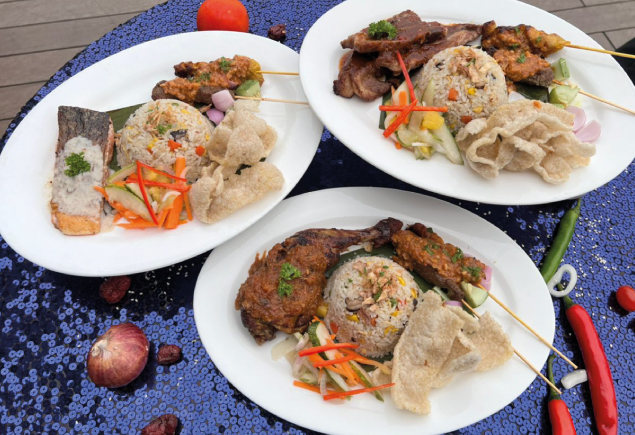Three plates of different Malaysian fried rice such as Grilled Lamb Shoulder Fried Rice, Grilled Cajun Chicken Fried Rice and Pan-Seared Salmon Fried Rice are placed on the table.