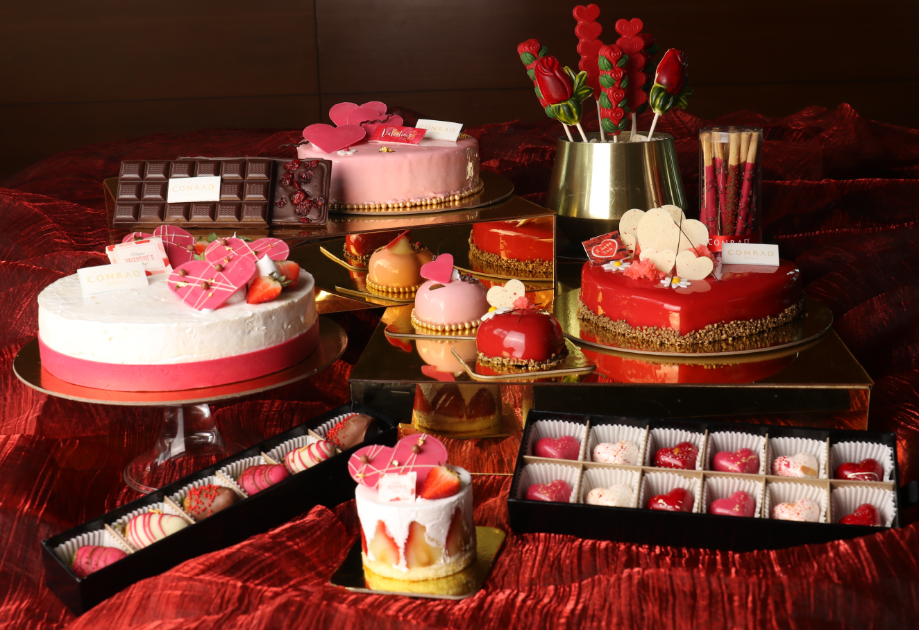 The photo shows a variety of Valentine's Day-themed desserts.