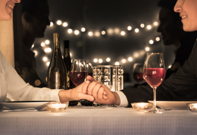 A couple is enjoying their time over a romantic dinner