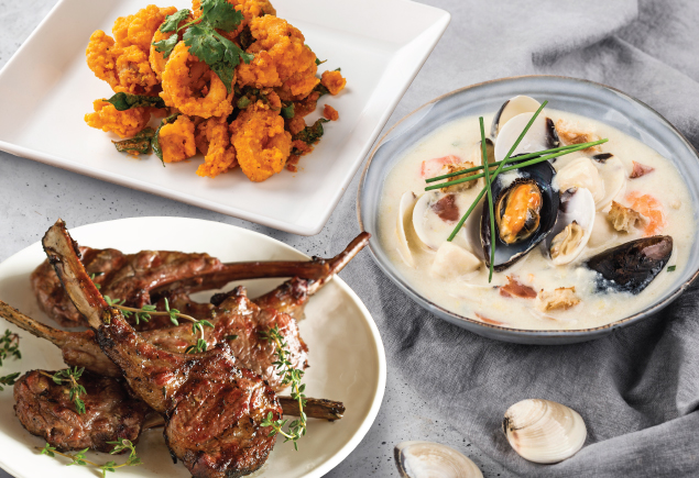 Three plates of cuisine such as Seafood Chowder, Cajun Marinated Lamb Chop and Paprika Marinated Squid are on the table.
