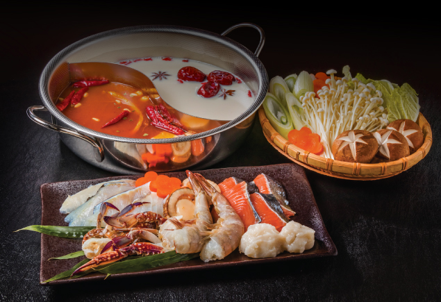 Hotpot with flavourful spicy broth and chicken broth. Served with fresh vegetables and seafood.