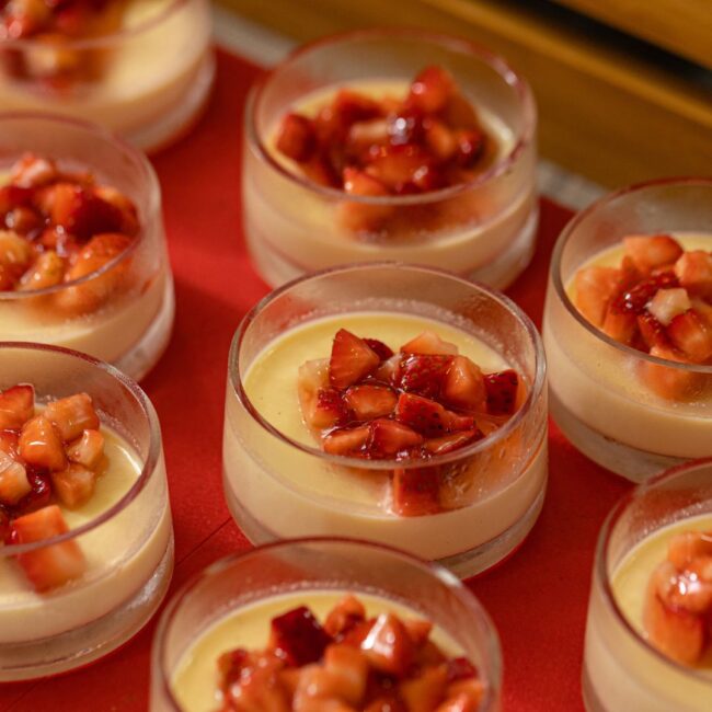 Strawberry and vanilla puddings in cups.
