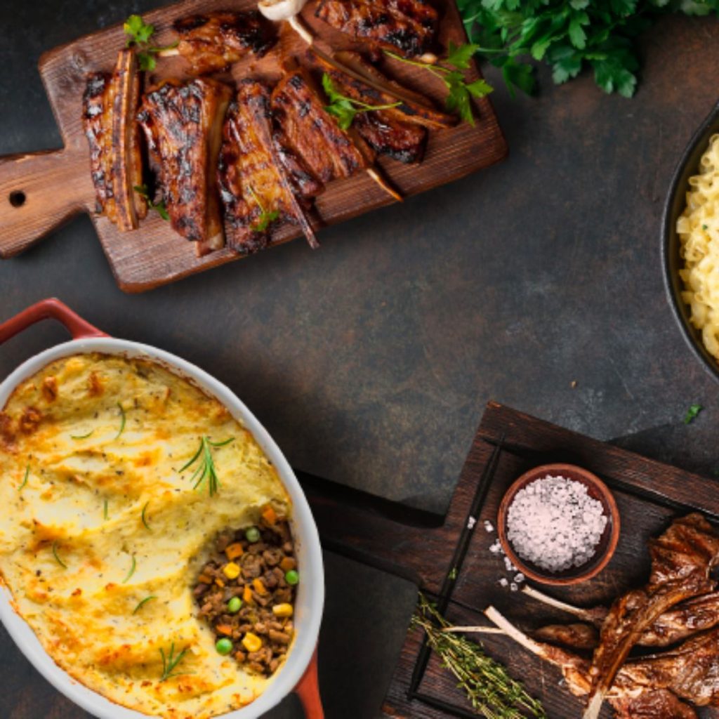 Three Western dishes such as Grilled Lamb, Grilled Ribs and more on the table.