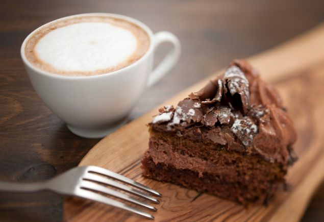 A slice or chocolate cake and a cup of coffee.