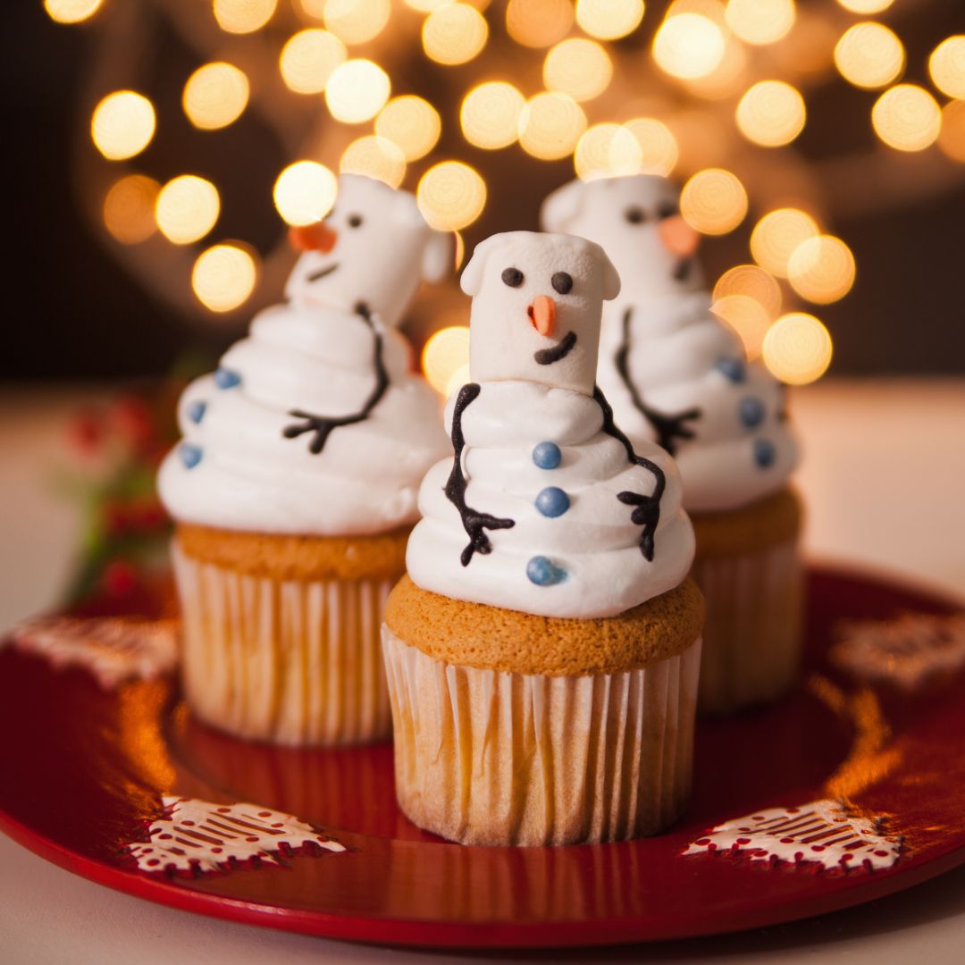 The photo shows three snowman cupcakes.