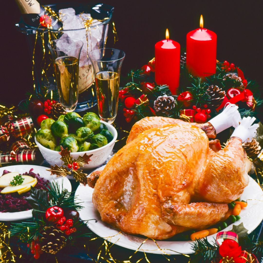 The photo shows a whole turkey with some Christmas decorations at the back.