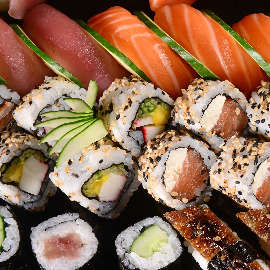 Close-up shot of assorted sushi and fresh sashimi.