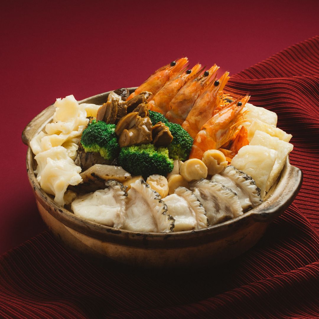 A bowl of Pun Choy with variety of seafood and vegetables.