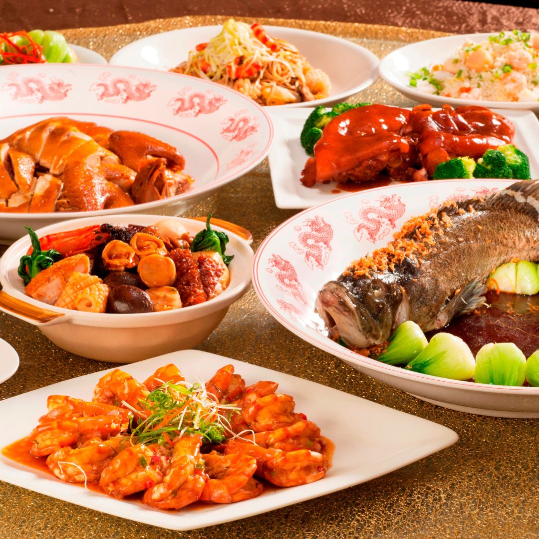A variety of Chinese dishes such as steamed soy sauce fish, chili prawns, poon choi, roasted chicken, fried rice and chow mein.