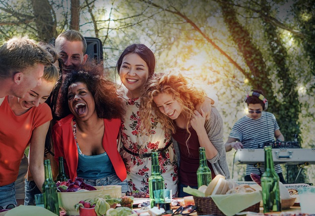 group of friends smiling and laughing together over gourmet food