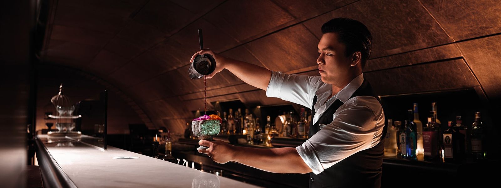 A mixologist mixing a cocktail