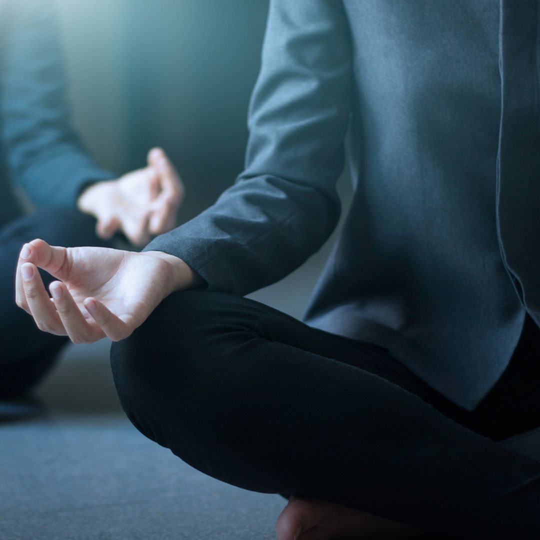 A man in suit meditating.